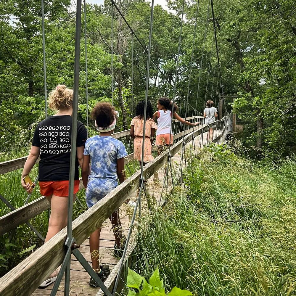 Kids walking across a bridge